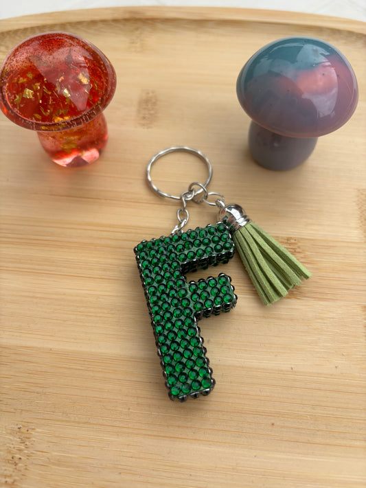 Porte clé en en forme de F strassé
